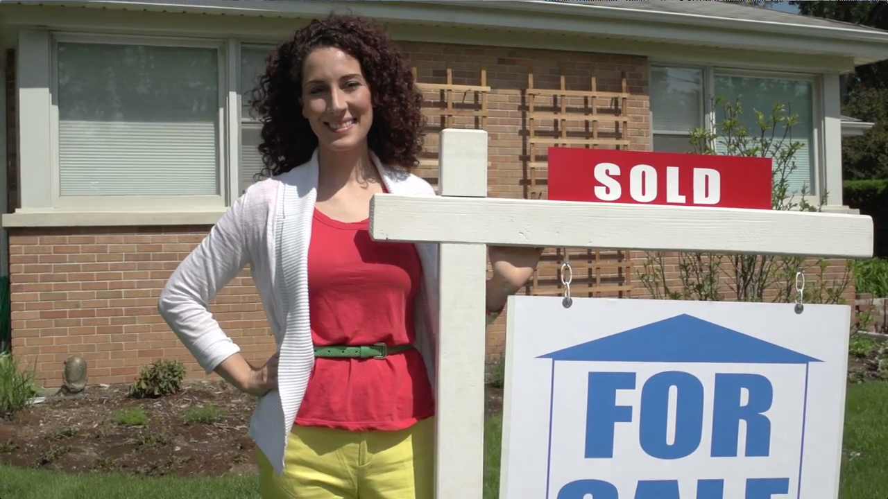 Real Estate Agent Next to For Sale Sign
